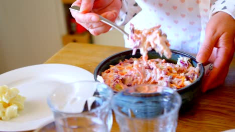 Woman-serving-meal-in-kitchen-at-home-4k