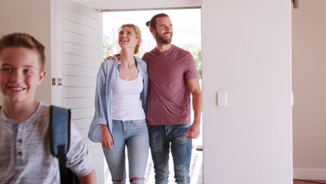 Family-Opening-Door-And-Walking-In-Empty-Lounge-Of-New-Home