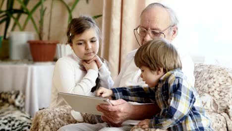 Grandfather-using-digital-tablet-with-grandchildren