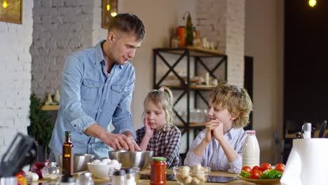 Man-Teaching-Two-Children-to-Cook