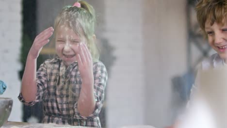 Siblings-Having-Fun-when-Cooking-in-Kitchen