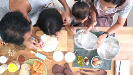 Top-view-happy-family-cooks-in-the-kitchen-at-home