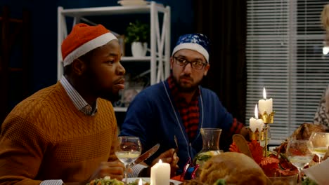 Diverse-friends-dining-together-at-Christmas