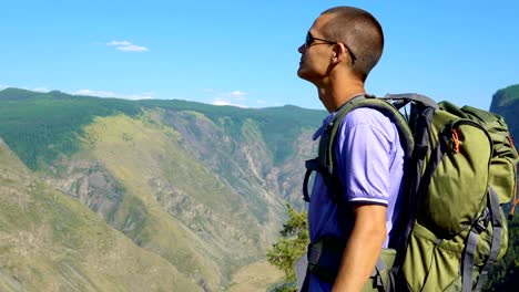 A-tourist-with-a-backpack-in-the-mountains.