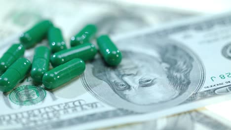 Medical-capsule-on-dollar-banknote.-Herbal-capsules-on-money-cash