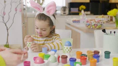 Girl-in-rabbit-costume-painting-eggs