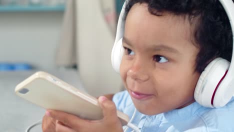 Little-African-Boy-Enjoying-Music-on-Mobile-Phone