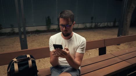 Closeup-of-a-guy-with-smartphone-at-night-outside.