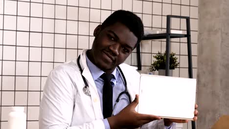 Smiling-doctor-presenting-product-on-a-tablet-computer.-White-Display