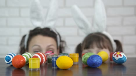 Easter.-A-woman-with-a-child-paint-eggs.