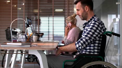 Close-up-of-man's-in-a-wheelchair-in-office