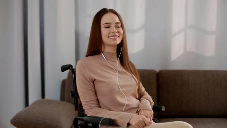 Young-disabled-woman-listening-music-at-home