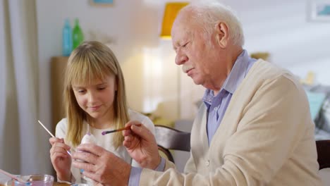 Grandfather-and-Granddaughter-Decorating-Easter-Eggs