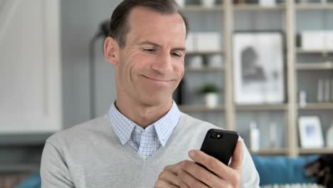 Portrait-of-Middle-Aged-Man-Busy-Using-Smartphone