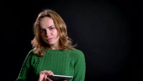 Closeup-portrait-of-adult-caucasian-female-using-tablet-and-being-thoughtful-in-front-of-the-camera