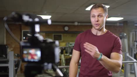 Cheerful-Gym-Coach-Waving-and-Speaking-on-Camera