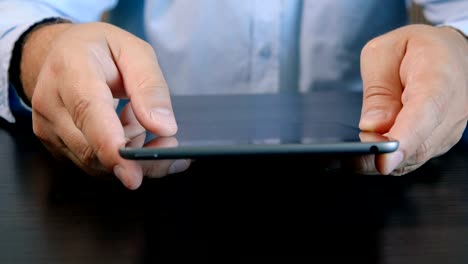 Man-hands-using-tablet-computer