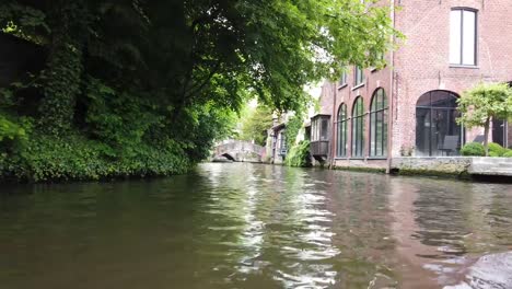 Bruges,-Belgium---May-2019:-View-of-the-water-channel-in-the-city-center.-Tourist-walk-on-the-water-canals-of-the-city.-View-from-a-tourist-boat.