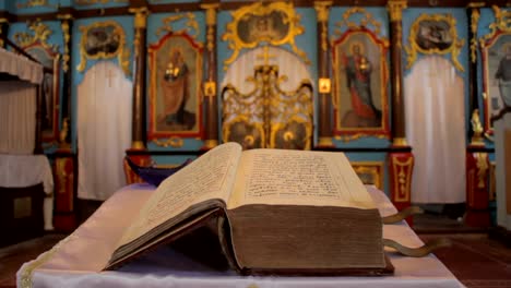 2-in-1-An-old-open-church-book-in-front-of-the-frescoes