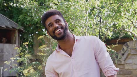 Portrait-Of-Smiling-Man-At-Home-In-Garden-Against-Flaring-Sunæ