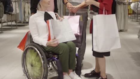 Paraplegic-Woman-Chatting-with-Friends-in-Clothing-Store