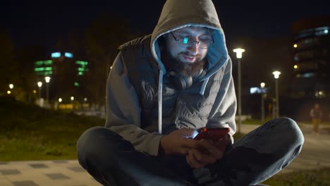 Young-man-with-smart-phone-in-the-park