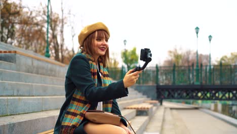 Young-vlogger-streaming-from-public-park-using-smartphone-and-steadicam