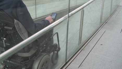 4k-resolution-follow-of-a-man-on-electric-wheelchair-using-a-ramp.-Accessibility-concept