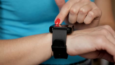 Frau-mit-ihrem-Smartwatch-Touchscreen-tragbare-Technologie-Gerät.-Mädchen-machen-Gesten-auf-einem-tragbaren-Smart-Watch-Computer-Gerät,-Nahaufnahme.