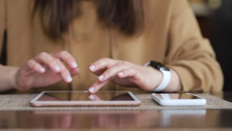 Girl-is-using-her-digital-tablet-both-hands