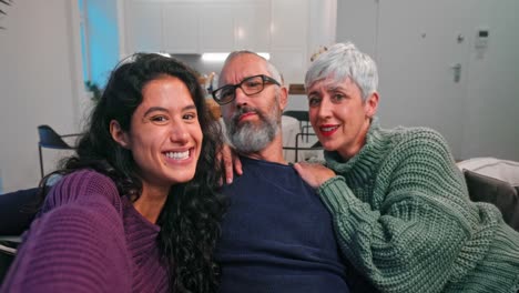 Family-taking-funny-selfie-with-smartphone-on-sofa