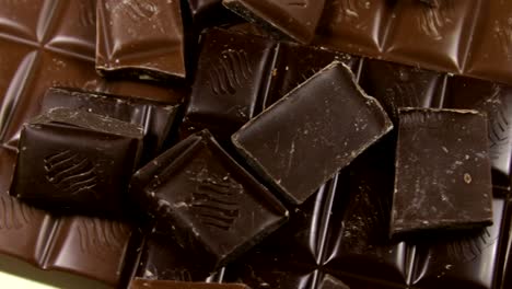 Milk-and-dark-chocolate-tiles-on-a-wooden-background.chocolate-bars-close-up