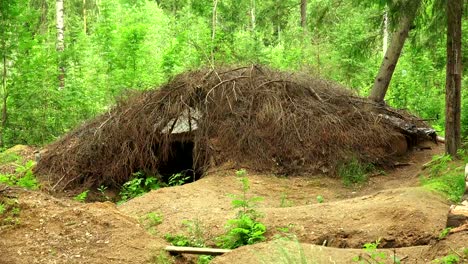 Military-earth-houses-and-huts-in-the-forest.-4K.