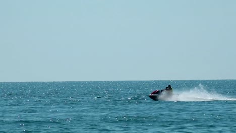 Young-Man-on-Jet-Ski.-Professional-rider-Championship.-Jetski-performs-many-tricks-on-the-waves.Young-Man-on-Jet-Ski.-Professional-rider-Championship.-Jetski-performs-many-tricks-on-the-waves.