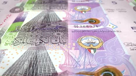 Banknotes-of-five-kuwaiti-dinar-rolling-on-screen,-cash-money,-loop