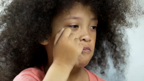 Resentful-African-American-kid-with-Down-syndrome-sitting-at-the-table,-health