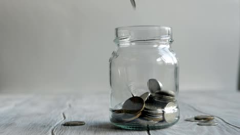 Coins-falling-into-the-jar.-Savings-in-the-jar