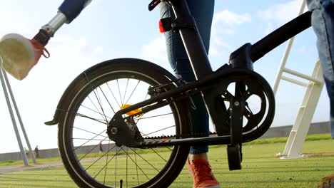 Geringen-Teil-der-behinderte-Frau-sitzen-auf-dem-Fahrrad-in-den-Park-4k