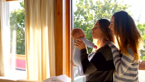 Lesbian-couple-holding-their-baby-boy-4k