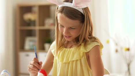 happy-girl-coloring-easter-eggs-at-home