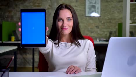 Woman-watches-into-the-tablet-and-shows-its-display-to-the-camera