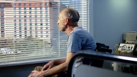 Elderly-male-patient-in-hospital-near-the-window