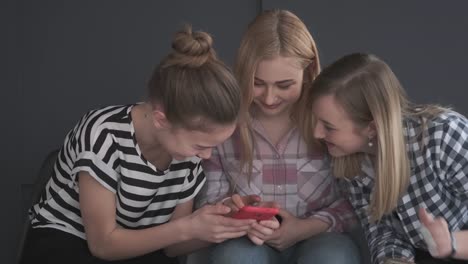 Laughing-teenage-girls-using-mobile-phone