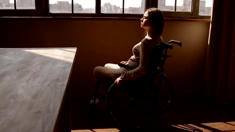 Disabled-young-woman-near-the-window