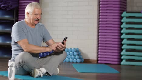 Retired-Man-Using-Phone-in-Sports-Hall