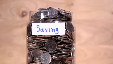 Close-up-save-coin-in-the-bottle-glass