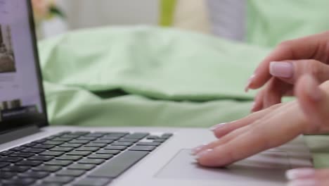 two-ordinary-girls-lying-on-the-bed-and-choose-the-goods-in-the-online-store