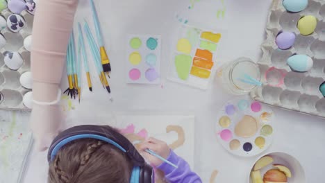 Little-girl-and-her-mom-painting-Easter-art-project