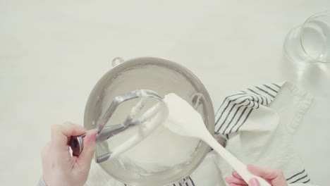 Mixing-royal-icing-to-decorate-Easter-sugar-cookies.