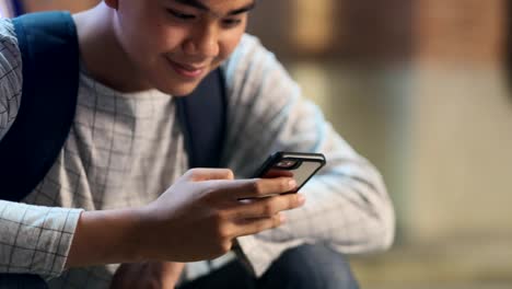 Young-man-using-mobilephone-online-chat.